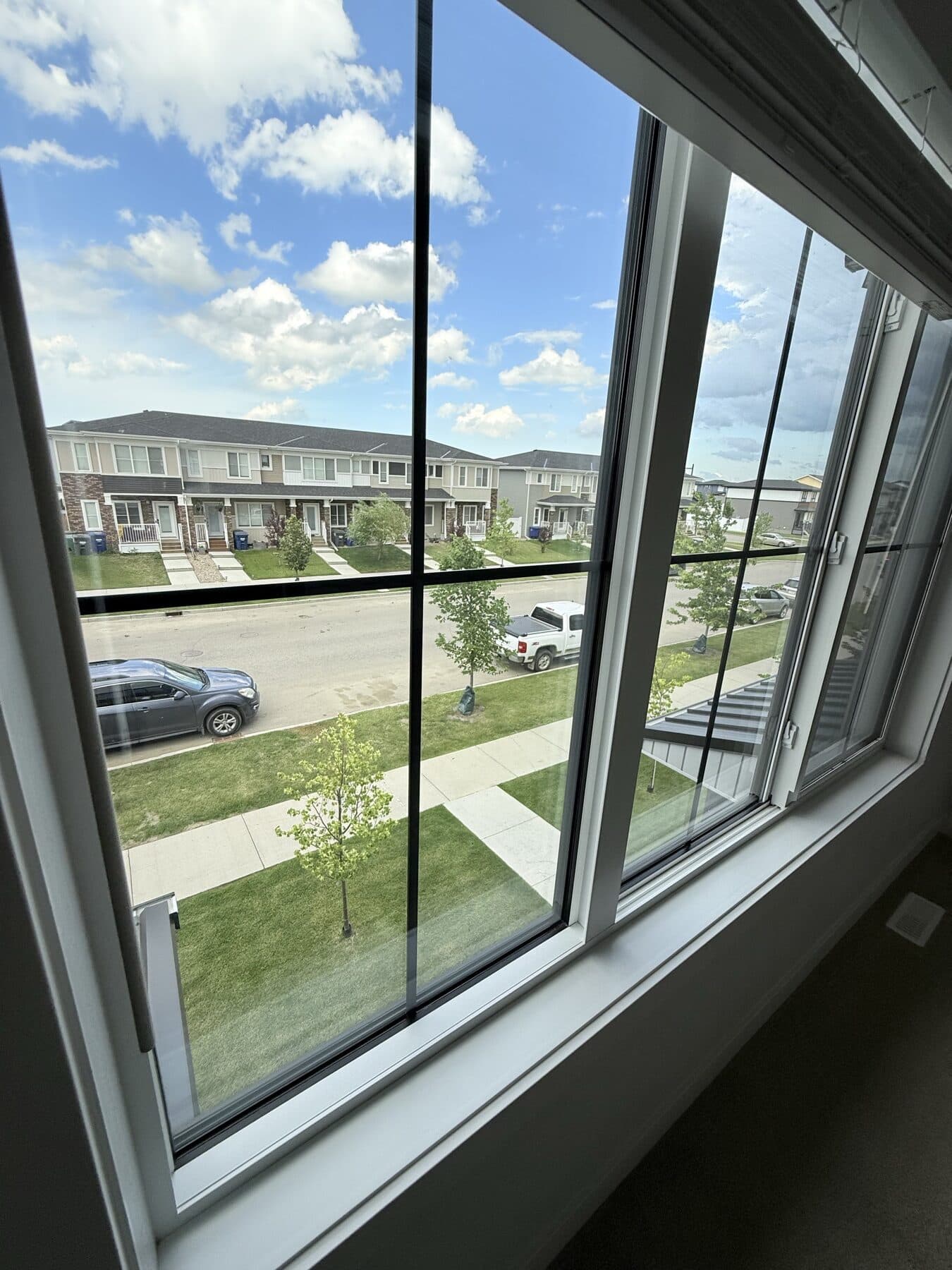 Clean residential window and sill overlooking a Saskatoon neighbourhood
