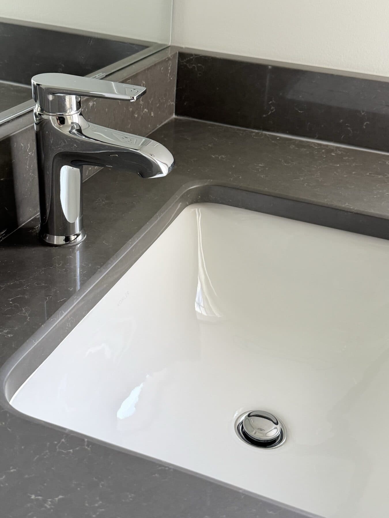 Polished bathroom sink and chrome faucet after a GM Cleaning service